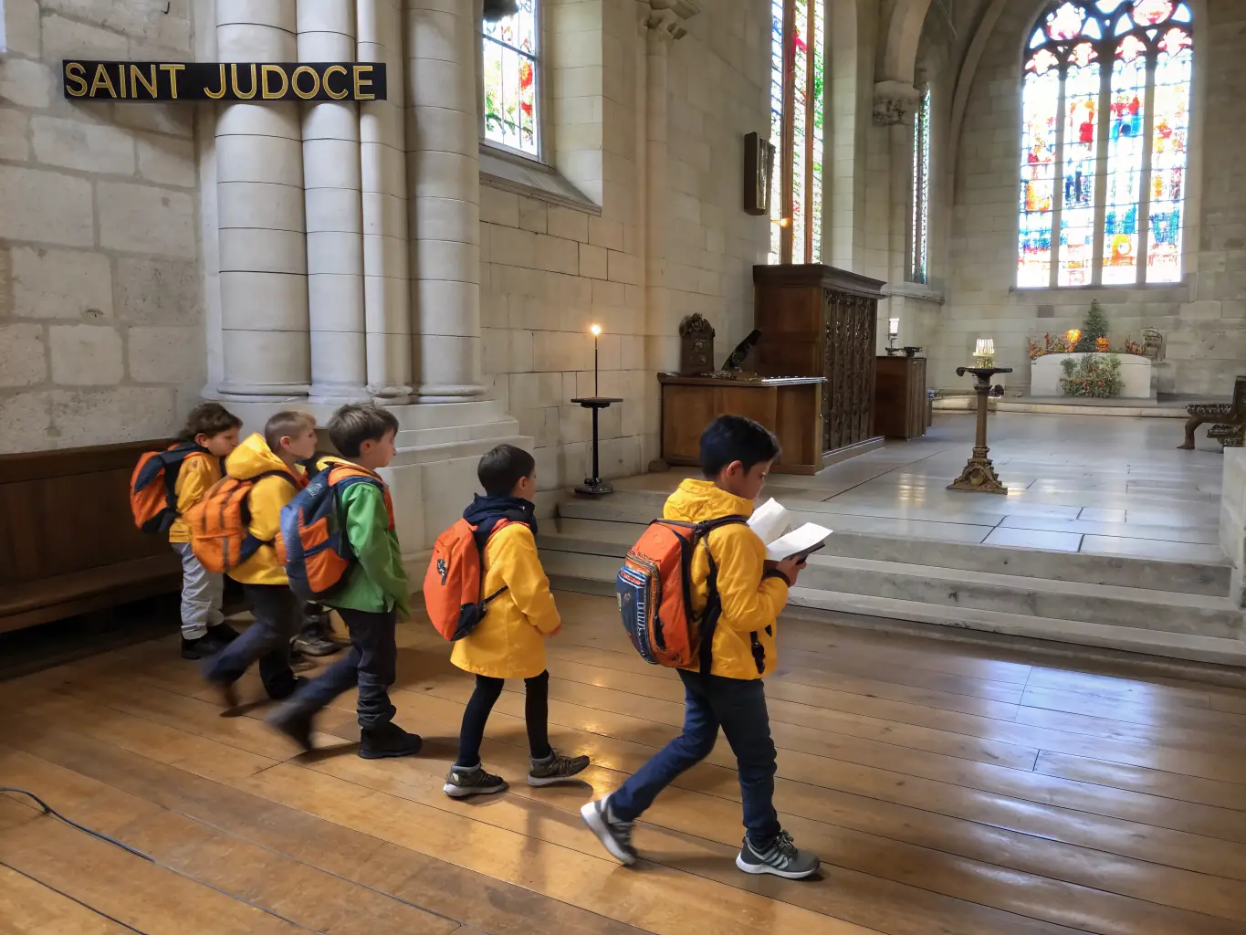 A photograph showcasing a group of children participating in an educational workshop about the organ, held within the Église Saint-Léger. The image highlights the interactive and engaging nature of the program.